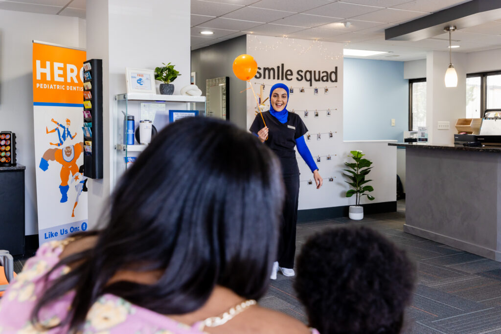Pediatric dentist in Herndon welcoming a patient and her mom.
