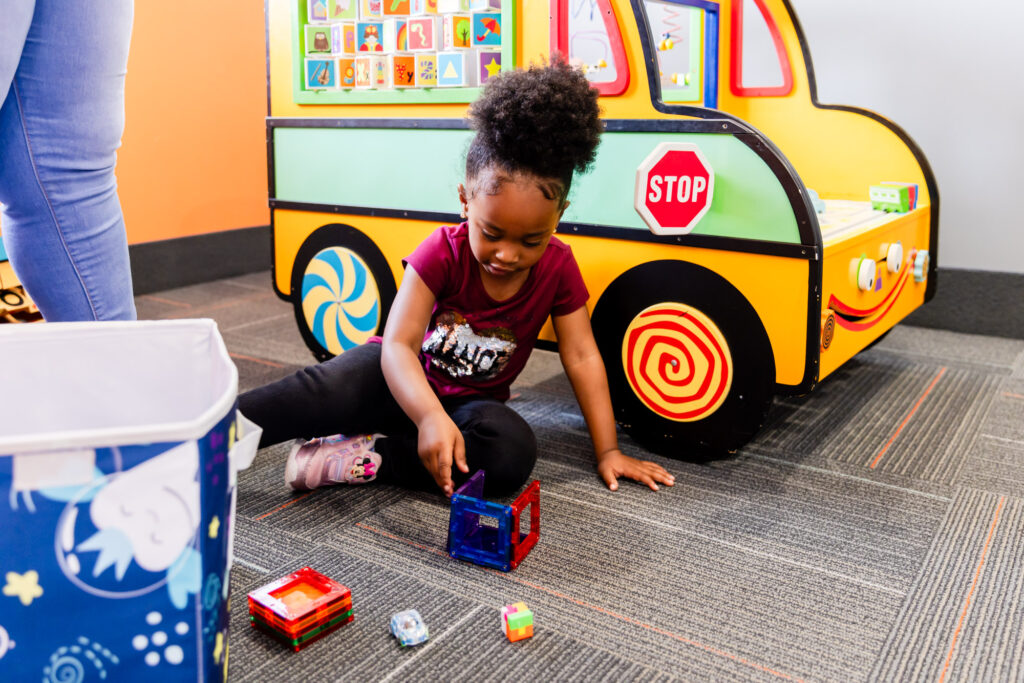Young girl playing with toys at our pediatric dental office in Herndon.
